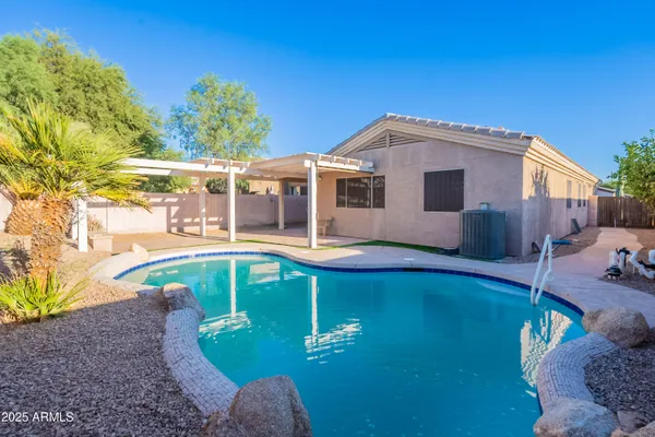 a view of a house with pool yard and a patio