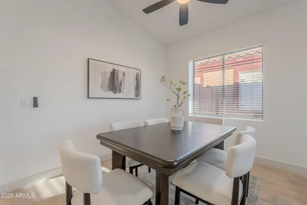 a view of a dining room with furniture and a window