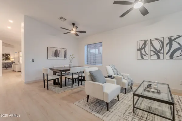 a living room with furniture and a dining table