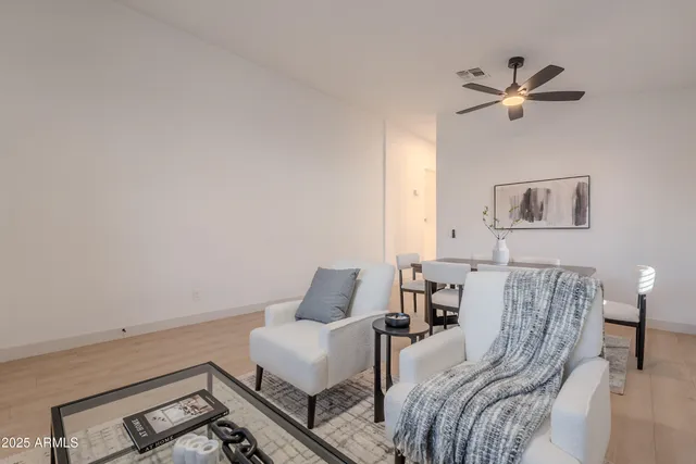 a spacious bedroom with a bed a couch and a large window