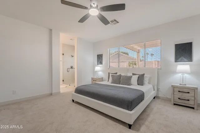 a bedroom with a bed and a large window