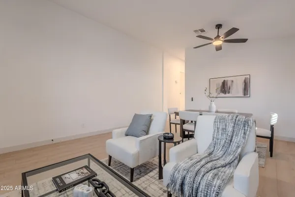 a spacious bedroom with a bed a couch and a large window