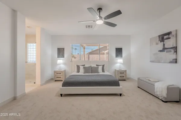 a bedroom with a bed and a chandelier