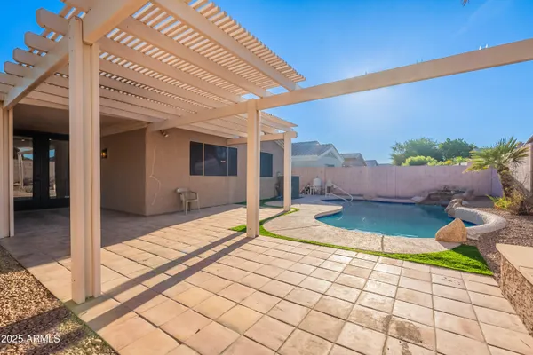 a view of a house with a backyard