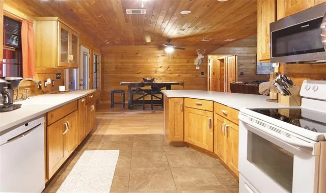a kitchen with stainless steel appliances granite countertop a sink and cabinets