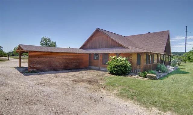 a view of house with yard and green space
