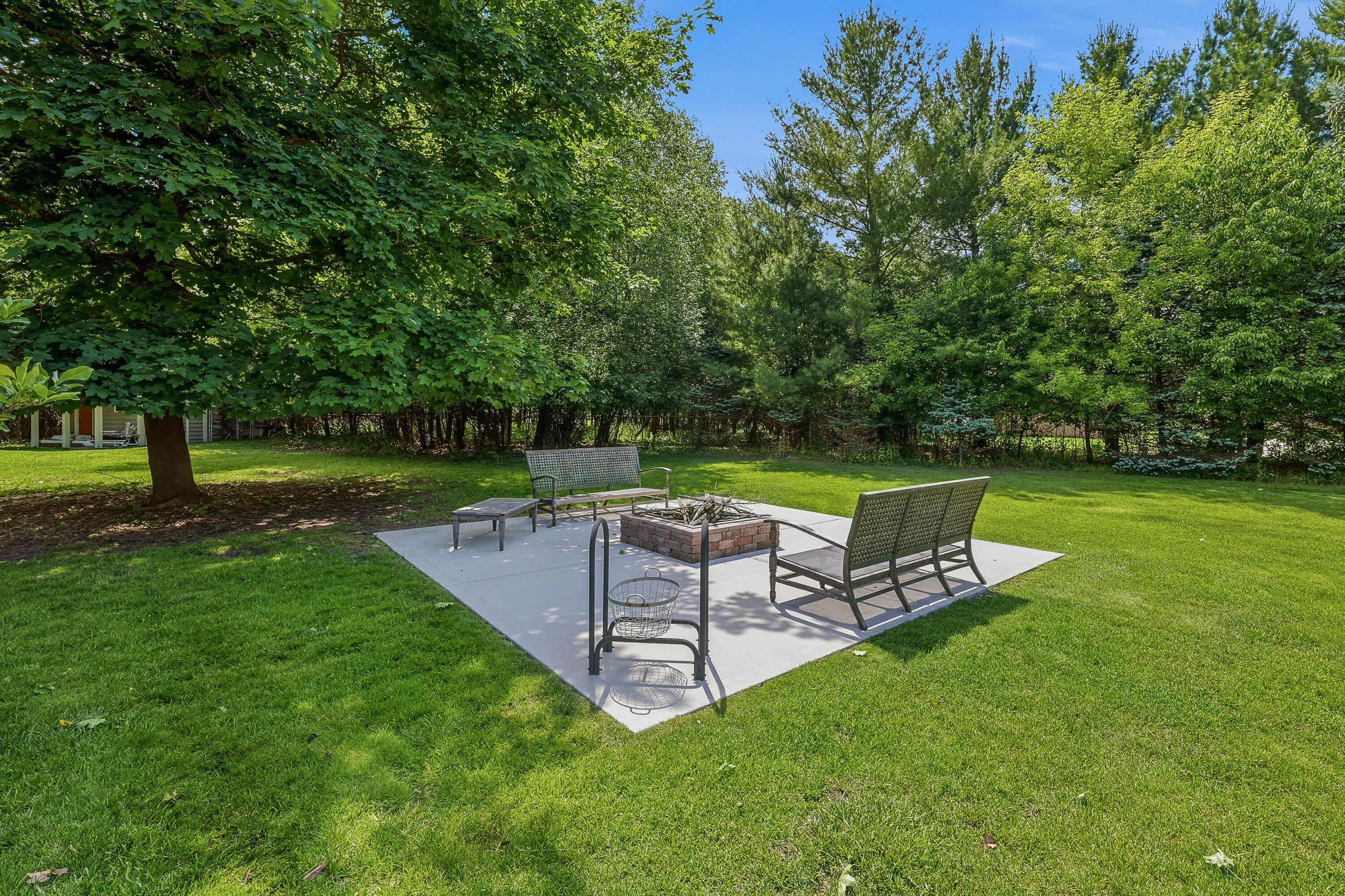 34899 Pabst Road Summit, WI 53066 - Photo 23 of 38 Smartly designed fire pit area with a dedicated surface so chairs stay level and don’t sink into the grass—ready whenever you want to enjoy a fire.