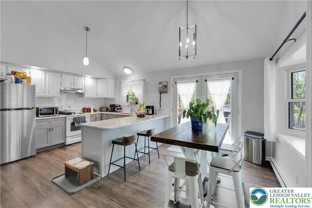 107 Shenkel Road Effort, PA 18330 - Photo 11 of 44 a kitchen with a dining table chairs sink and cabinets