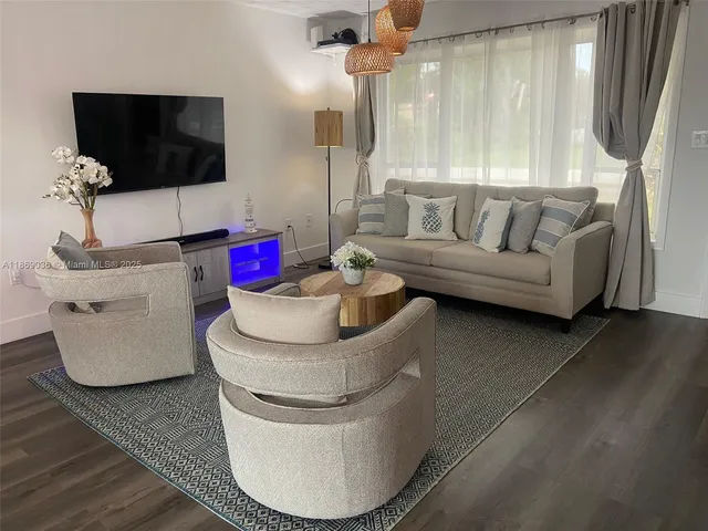 a living room with furniture and a flat screen tv