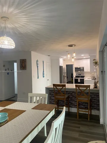 a kitchen with stainless steel appliances granite countertop a stove and a refrigerator