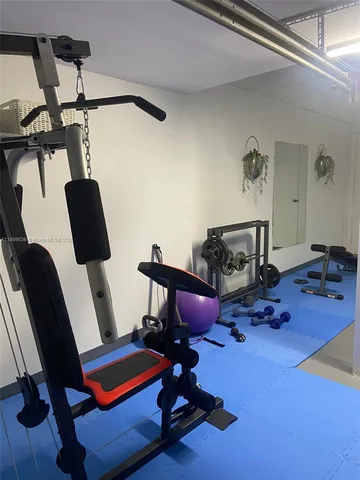 a living room with furniture and gym equipment