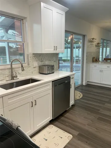 a kitchen with a sink and cabinets
