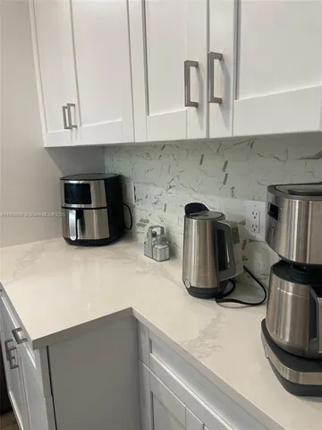 a kitchen with a sink and a stove top oven