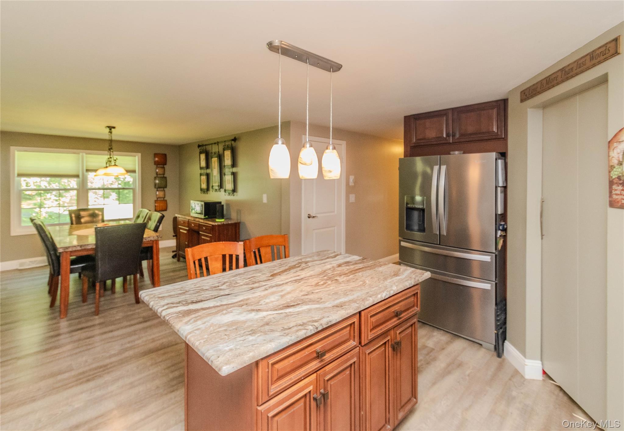 15 Van Dewark Road Middletown, NY 10941 - Photo 8 of 41 Kitchen island with a light-toned stone countertop, wood cabinetry, and pendant lighting