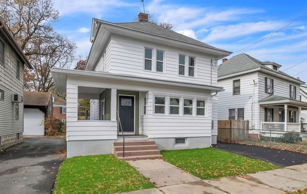 a front view of a house with a garden