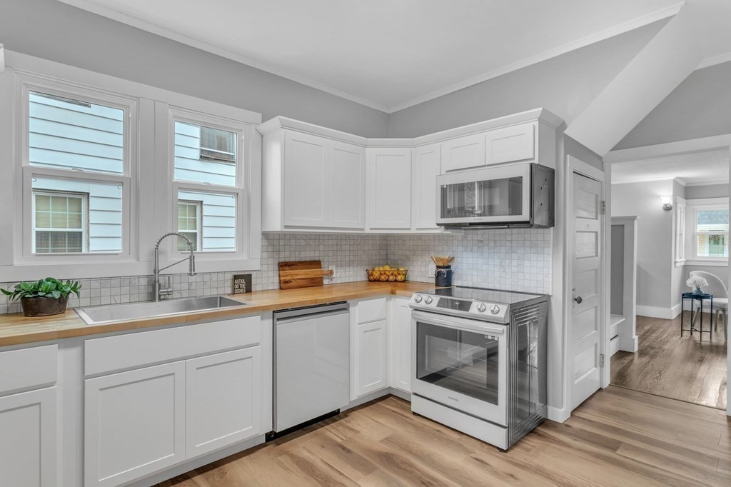 34 Brunswick Street Springfield, MA 01108 - Photo 12 of 31 a kitchen with a sink stove and microwave