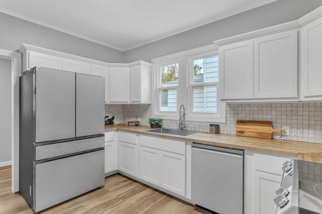 34 Brunswick Street Springfield, MA 01108 - Photo 13 of 31 a kitchen with white cabinets and white appliances