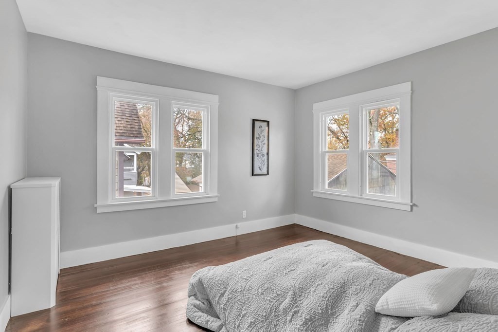 34 Brunswick Street Springfield, MA 01108 - Photo 16 of 31 a bedroom with a bed and wooden floor