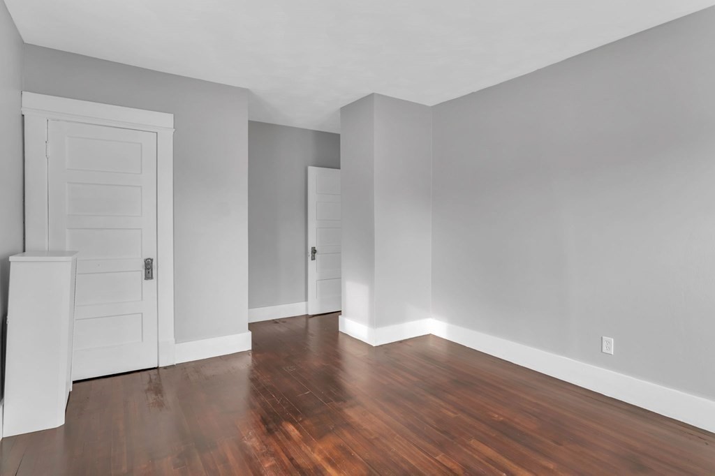 34 Brunswick Street Springfield, MA 01108 - Photo 18 of 31 a view of an empty room with wooden floor
