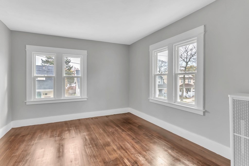34 Brunswick Street Springfield, MA 01108 - Photo 19 of 31 a view of an empty room with wooden floor and a window