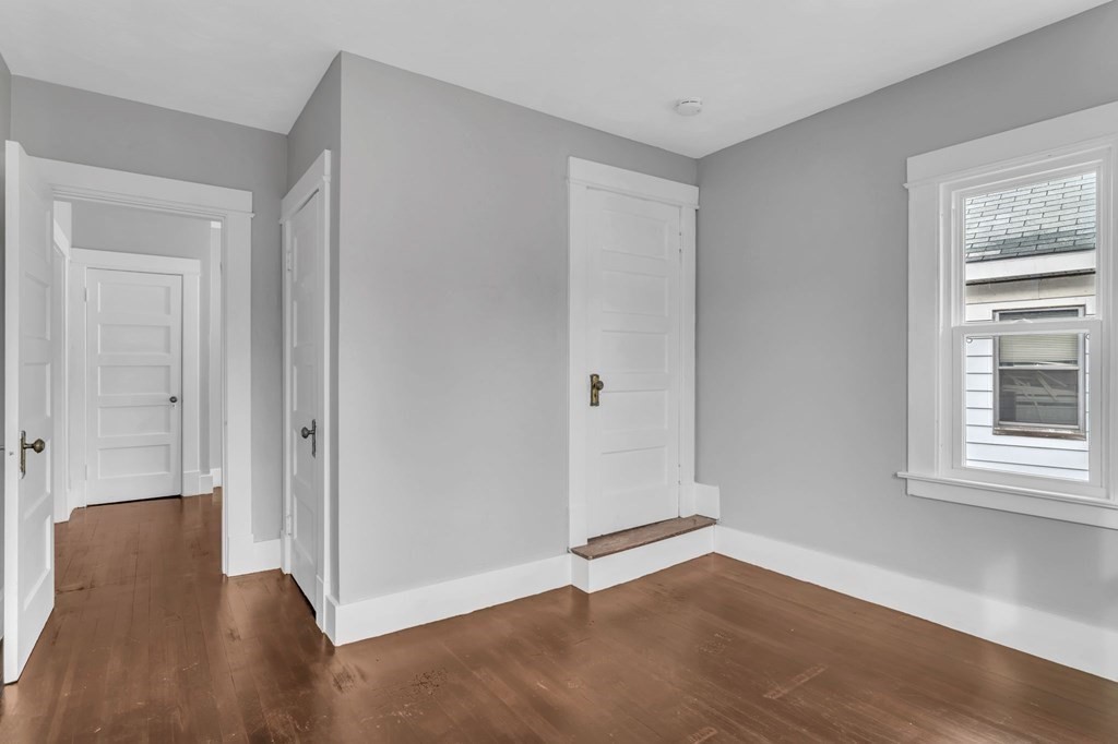 34 Brunswick Street Springfield, MA 01108 - Photo 20 of 31 a view of an empty room with wooden floor and a window