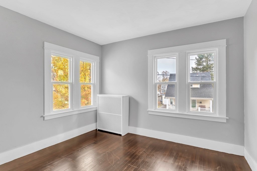 34 Brunswick Street Springfield, MA 01108 - Photo 21 of 31 a view of an empty room with wooden floor and a window