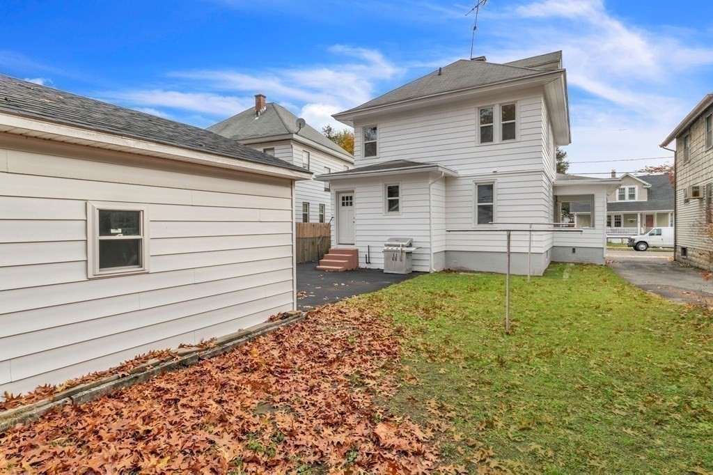 34 Brunswick Street Springfield, MA 01108 - Photo 30 of 31 a view of a white house with a yard and lawn chairs