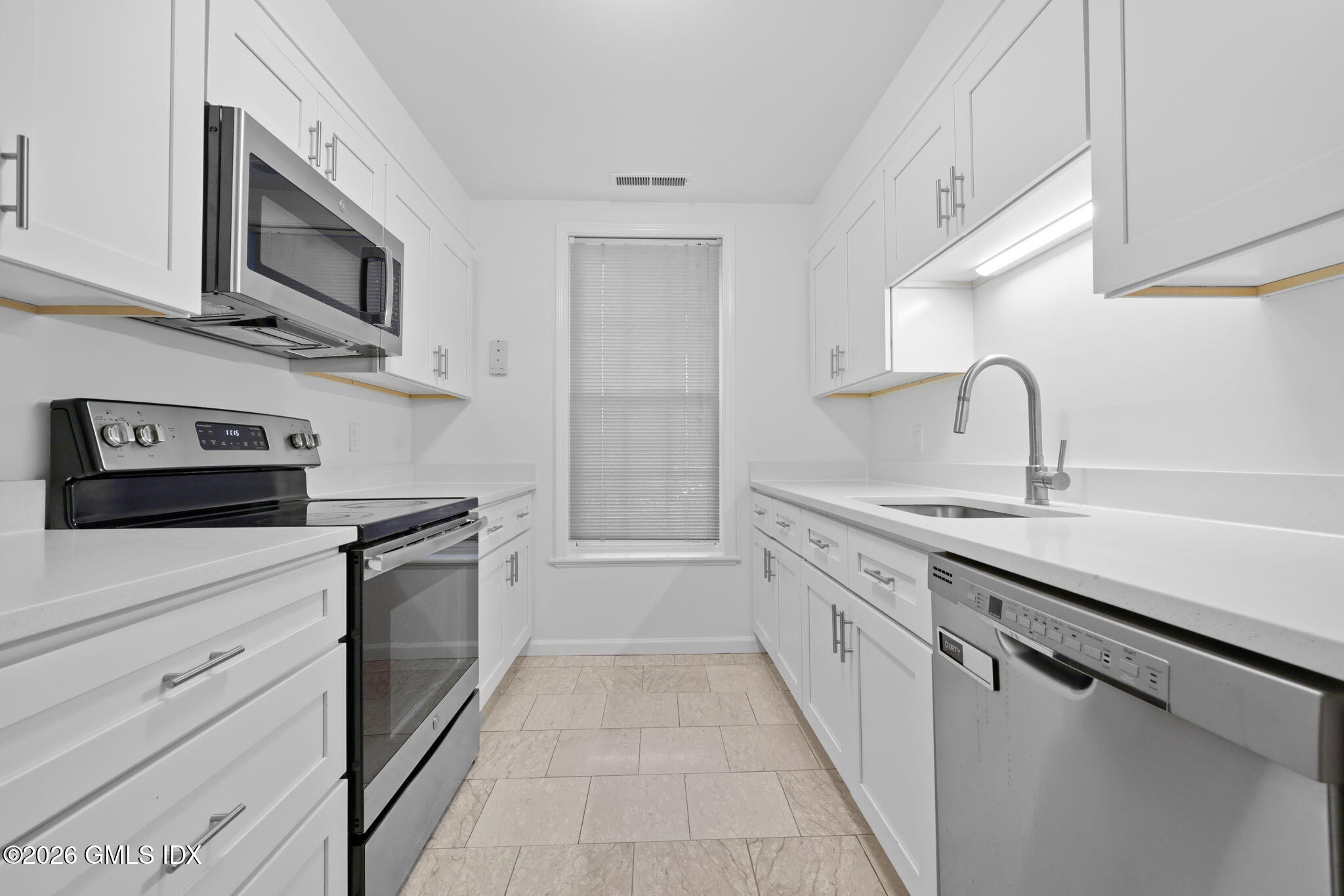 140 Field Point Road, Unit 2 Greenwich, CT 06830 - Photo 25 of 36 a kitchen with stainless steel appliances granite countertop a sink and a stove