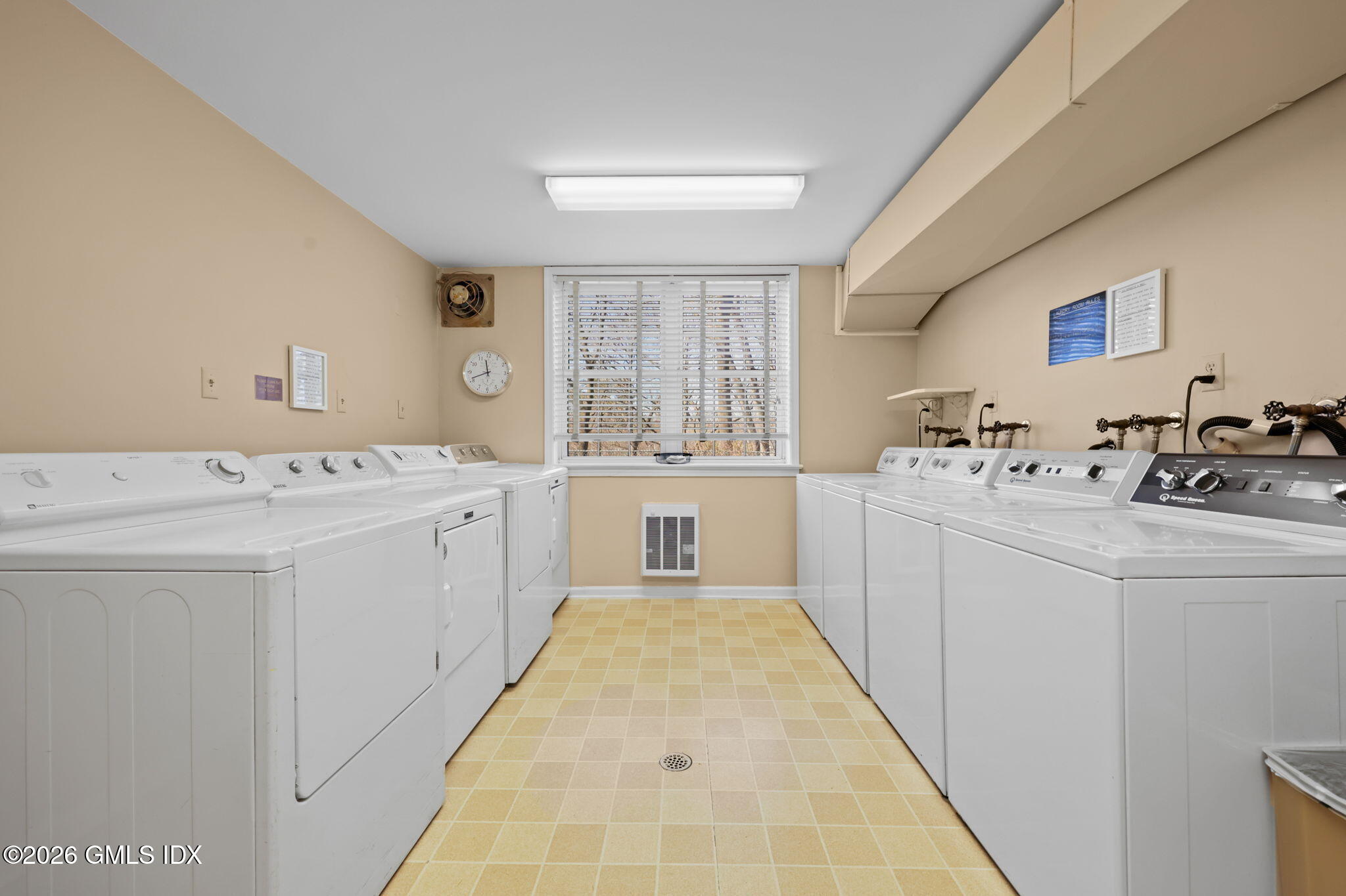 140 Field Point Road, Unit 2 Greenwich, CT 06830 - Photo 34 of 36 a utility room with cabinets washer and dryer