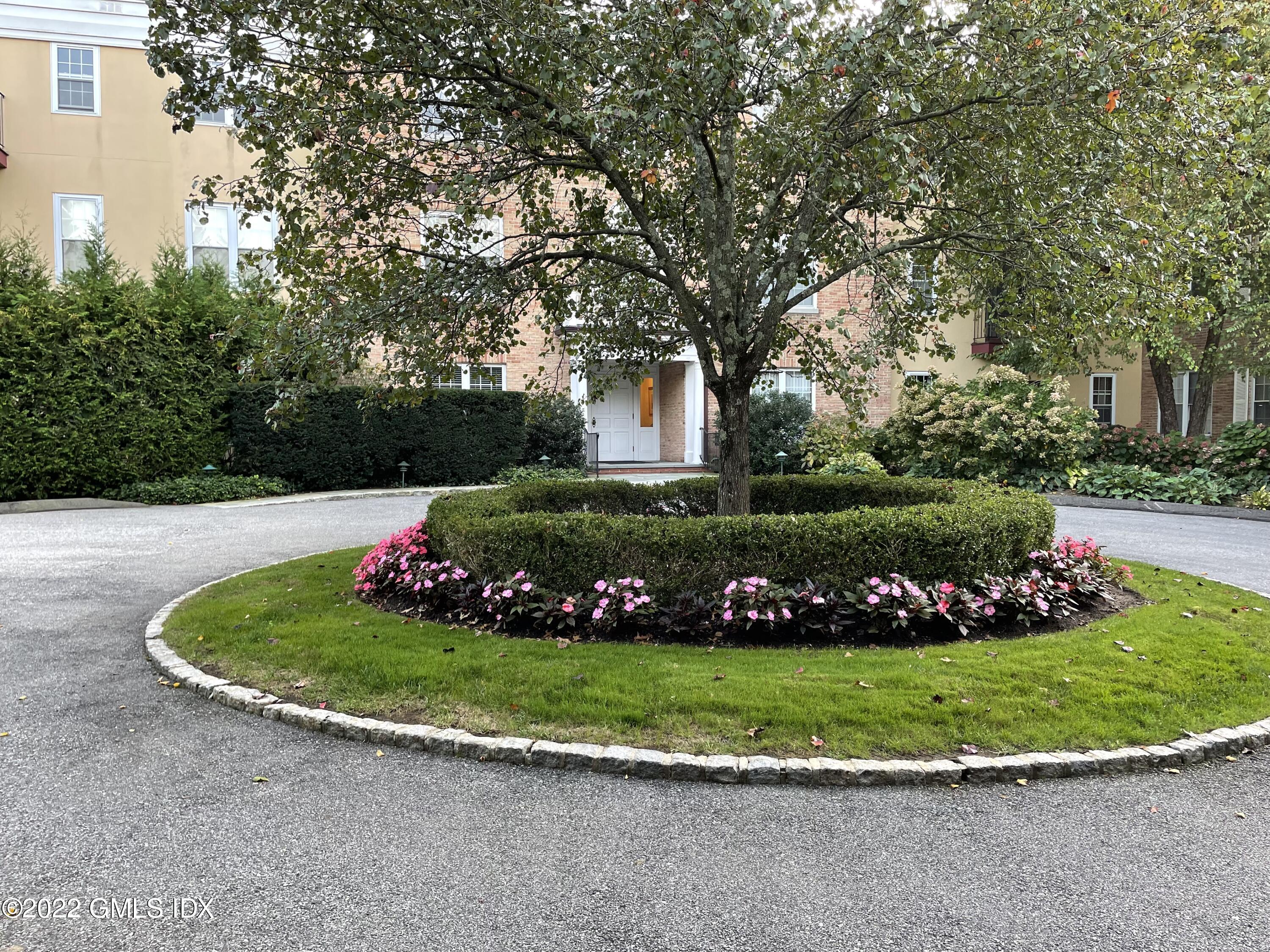 140 Field Point Road, Unit 2 Greenwich, CT 06830 - Photo 5 of 36 a view of a garden with flowers and trees