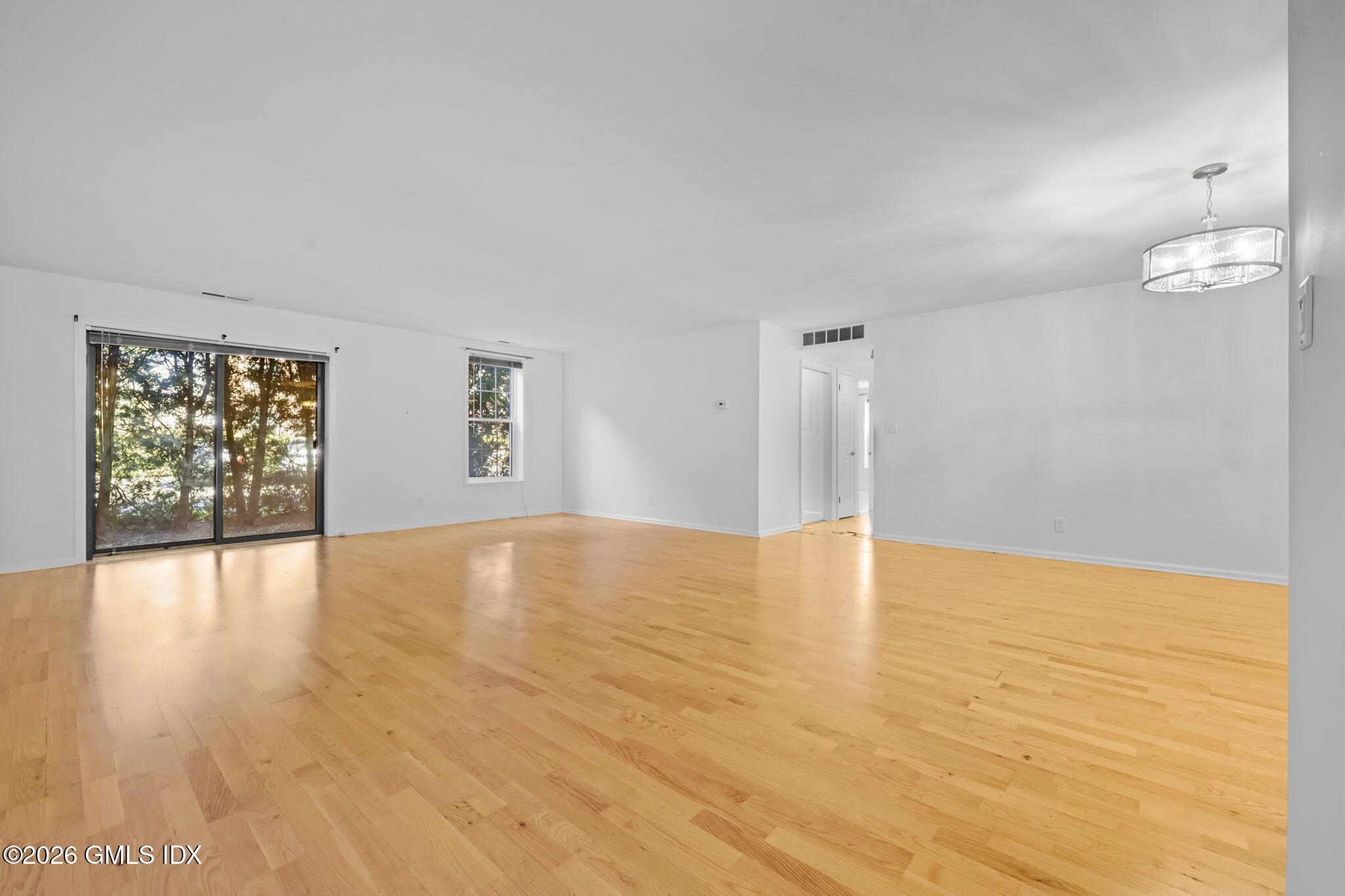 140 Field Point Road, Unit 2 Greenwich, CT 06830 - Photo 8 of 36 a view of empty room with wooden floor and fan