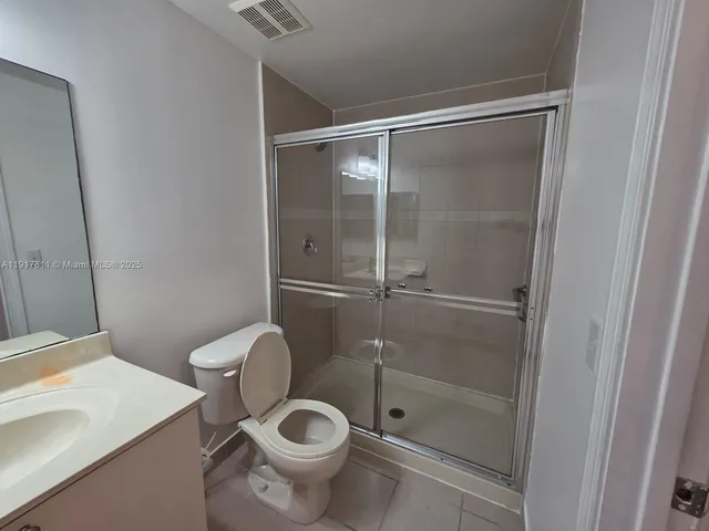 a white toilet sitting next to a bathroom sink
