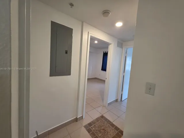 a view of hallway with bathroom