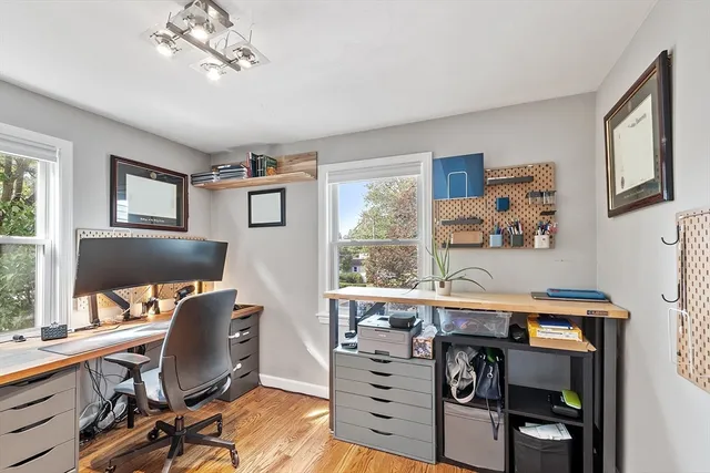 a view of a workspace with furniture and a window