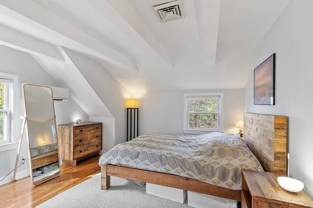 a bedroom with a bed and a television