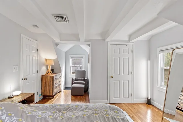 a bedroom with furniture and a wooden floor