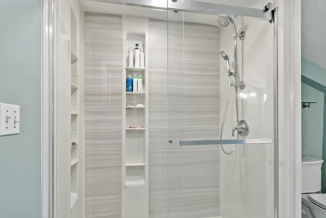 a bathroom with a glass shower door