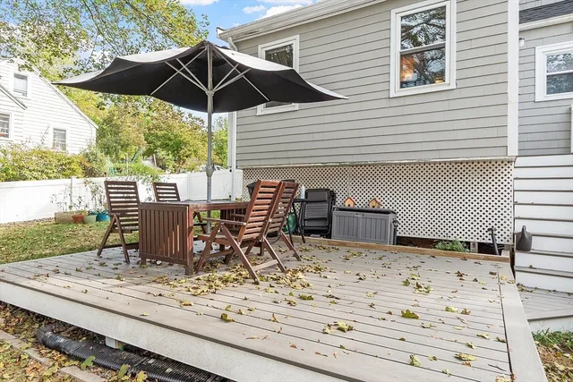 a view of a patio with a table and chairs under an umbrella