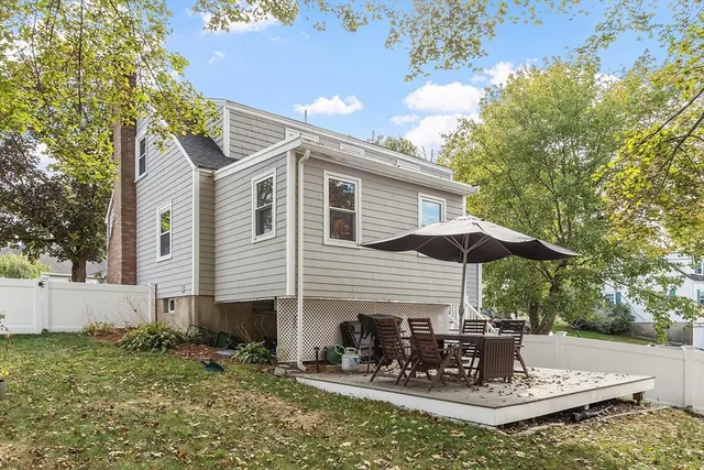 a view of a house with backyard and sitting area