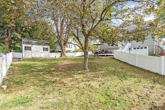 a backyard of a house with table and chairs