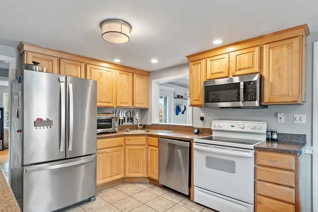a kitchen with a refrigerator sink and microwave