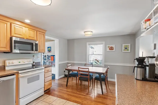a view of a dining room with furniture and a kitchen