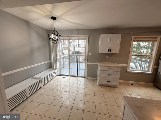 a room with a dresser and a chandelier
