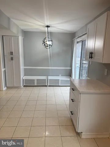 a view of an empty room with a chandelier