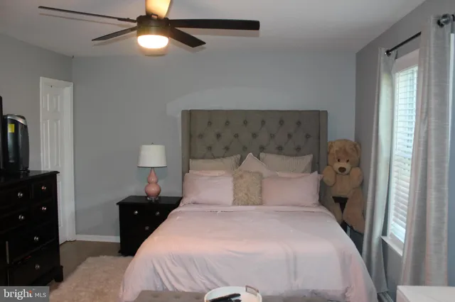 a bedroom with a bed and a tv