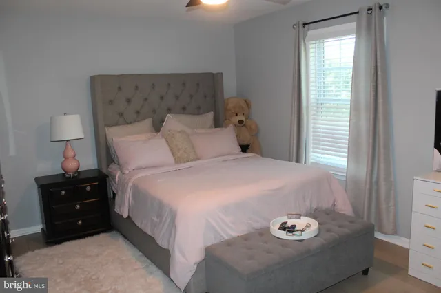 a bedroom with a bed and a lamp