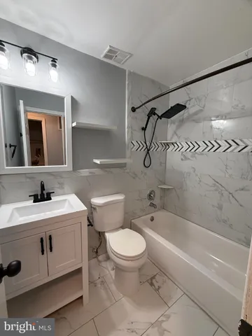 a bathroom with a sink a toilet and a bathtub
