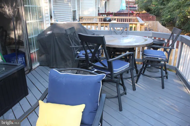 a view of a balcony with a table and chairs