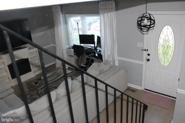 a view of a hallway with wooden floor and windows