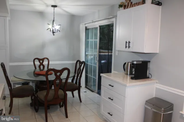 a view of a dining room with furniture and chandelier